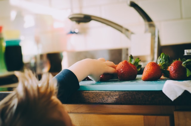 Baby Melody - Child reaching for strawberries