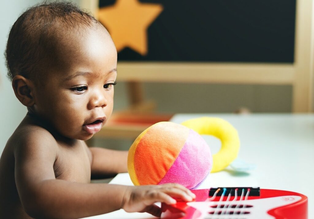 baby playing with guitar